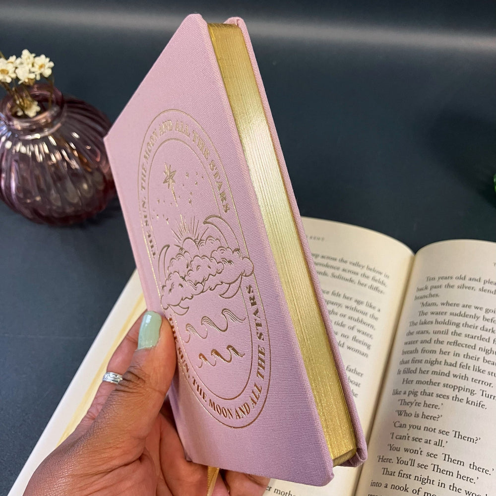 
                  
                    Pink Sun and Moon Notebook - The Willoughby Book Clubnotebook
                  
                
